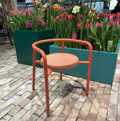 Cortado chair by Superlab for Nola featuring nimble design with low backrest and armrests in contemporary outdoor furniture