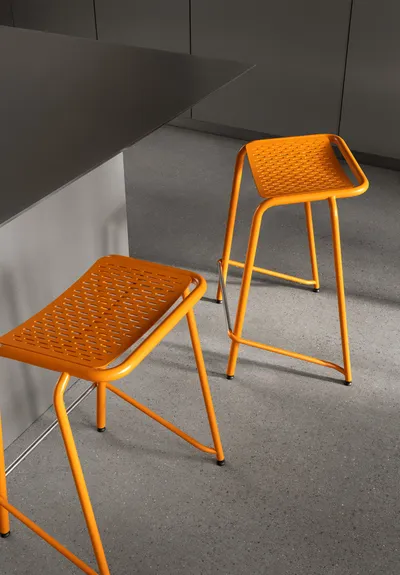 A22 stool by Anya Sebton featuring curved steel tubes in three diameters with laser-cut pattern and graphic character