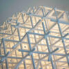 Lattice pendant by Charlotte von der Lancken, 3D-printed grid globe with moiré light effect