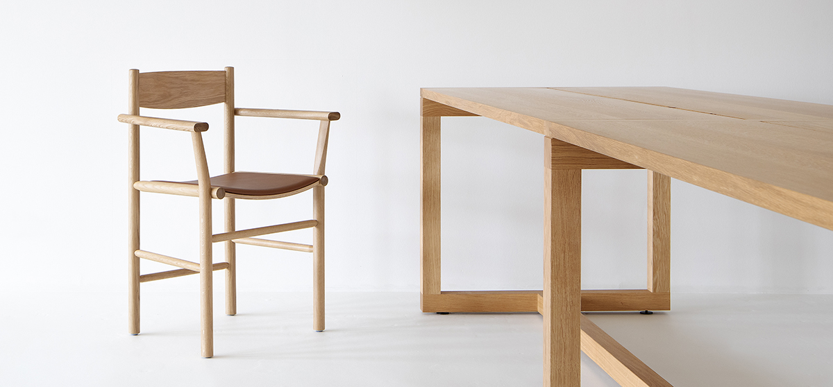 Akademia chair with armrests featuring curved seat and straight frame by Kaksikko for Nikari