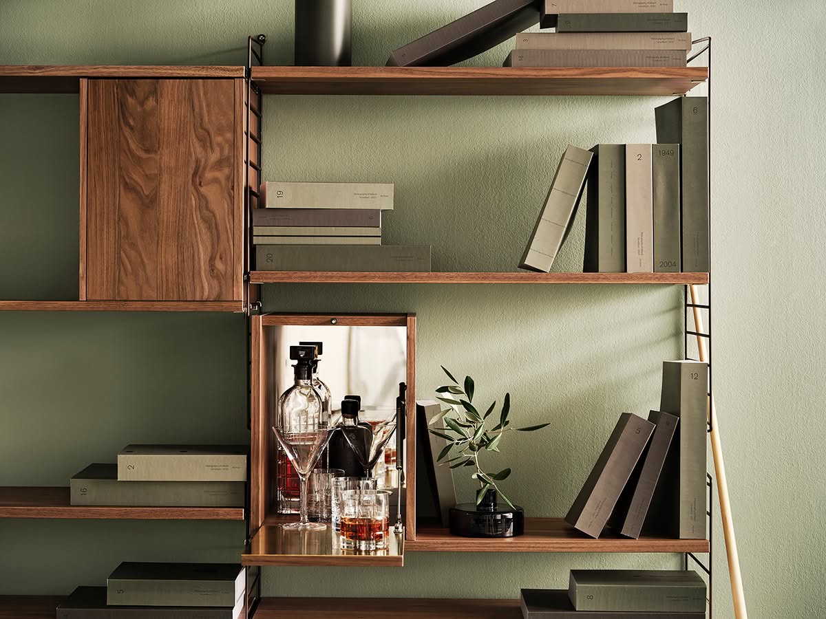 String Tiny Cabinet with mirrored back wall and brushed steel interior by Nisse Strinning