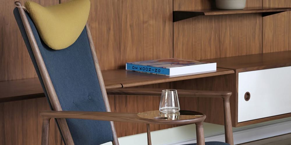Finn Juhl Whisky Chair relaunch featuring extravagant 1948 design with brass tray and mouth-blown glass