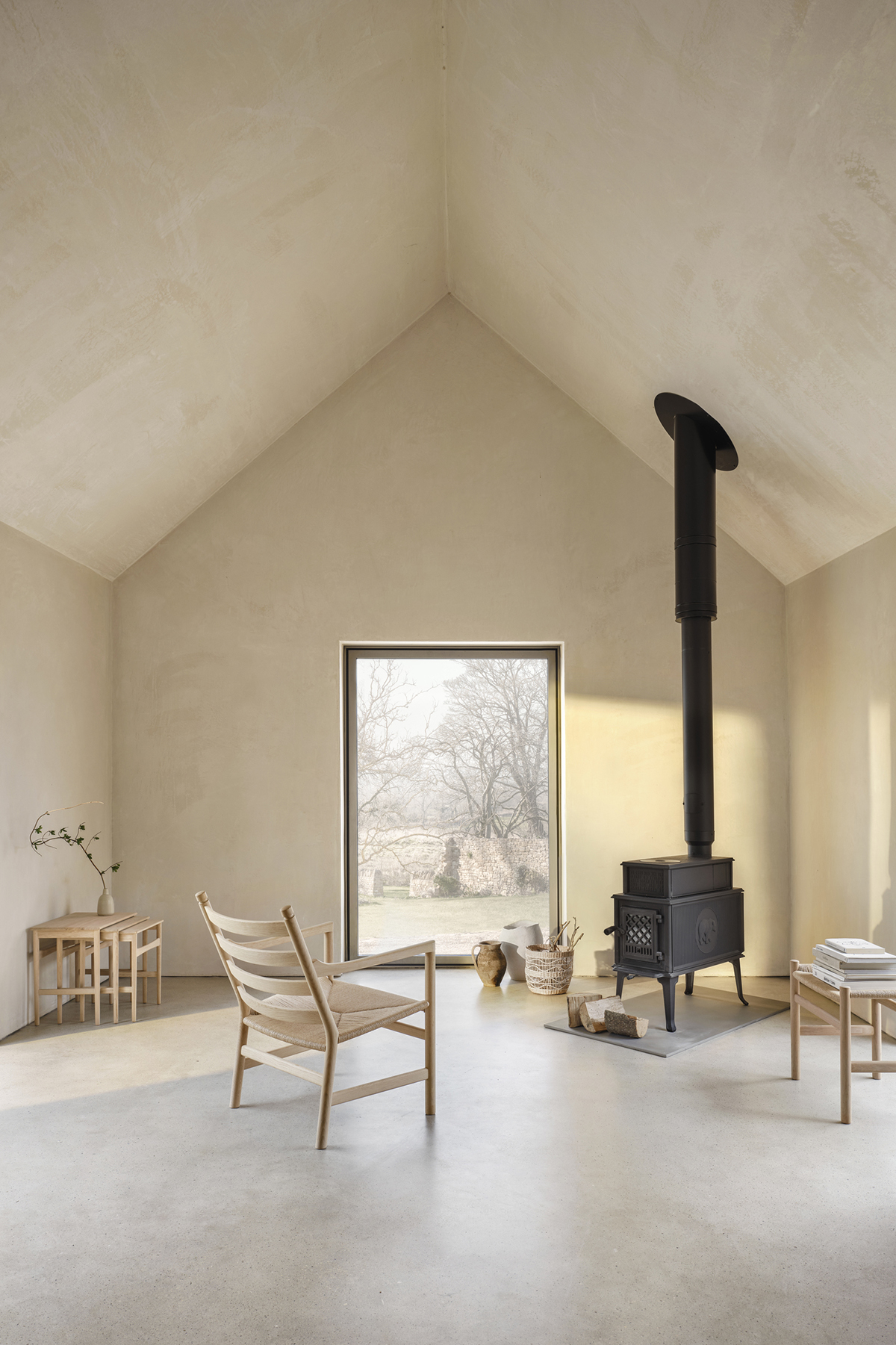 CH004 nesting tables by Hans J. Wegner featuring three graduated sizes with tapered legs and organic design details