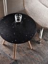Tinnef table featuring unique recycled plastic top with marbled patterns from waste bottle transformation