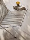 Close-up PK4 chair steel tubing and flag halyard weaving showing precision craftsmanship and material intersection