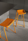 A22 stool by Anya Sebton featuring curved steel tubes in three diameters with laser-cut pattern and graphic character