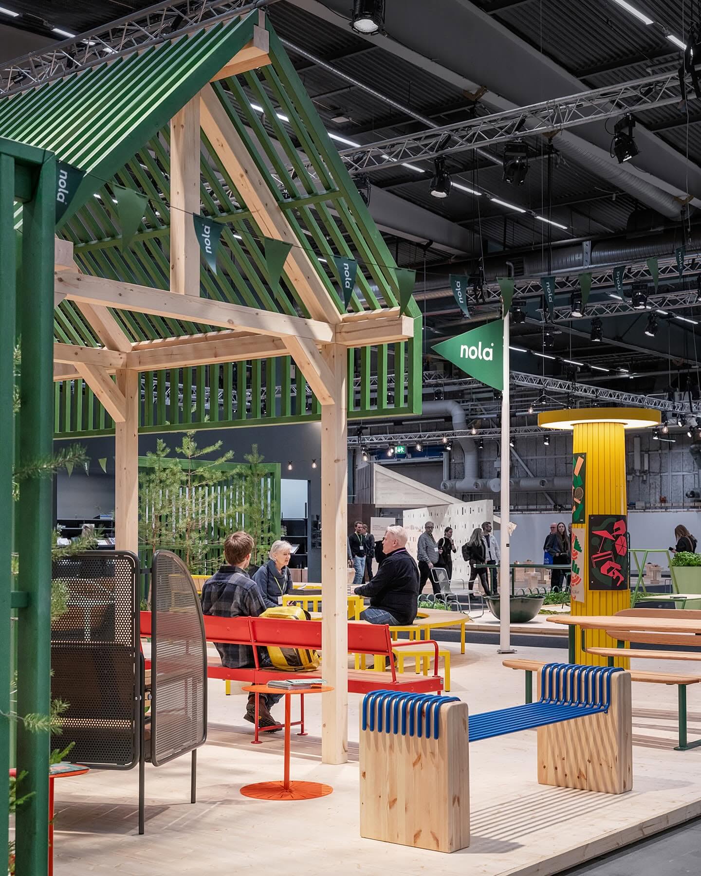 AROS bench by Alexander Morén for Nola featuring playful colors and curved form designed to enliven public spaces