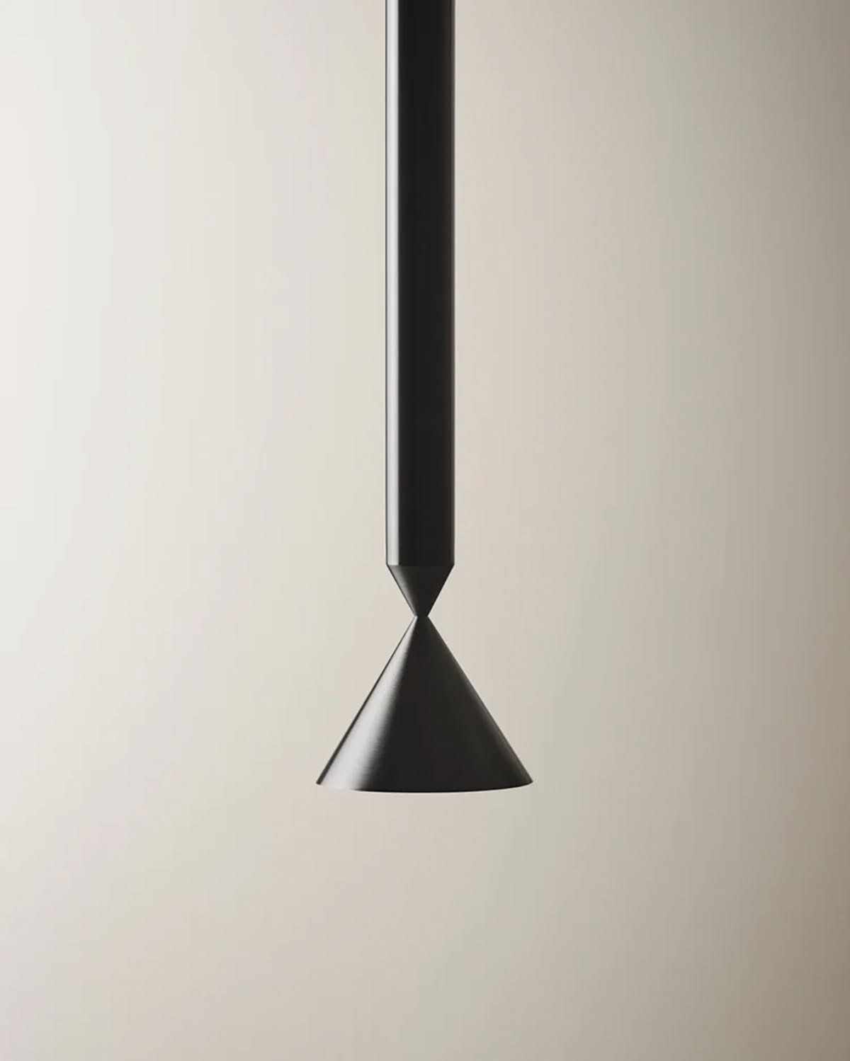Apollo pendant lamp in matte black aluminum suspended over dining table, casting focused downlight with minimalist sculptural presence.