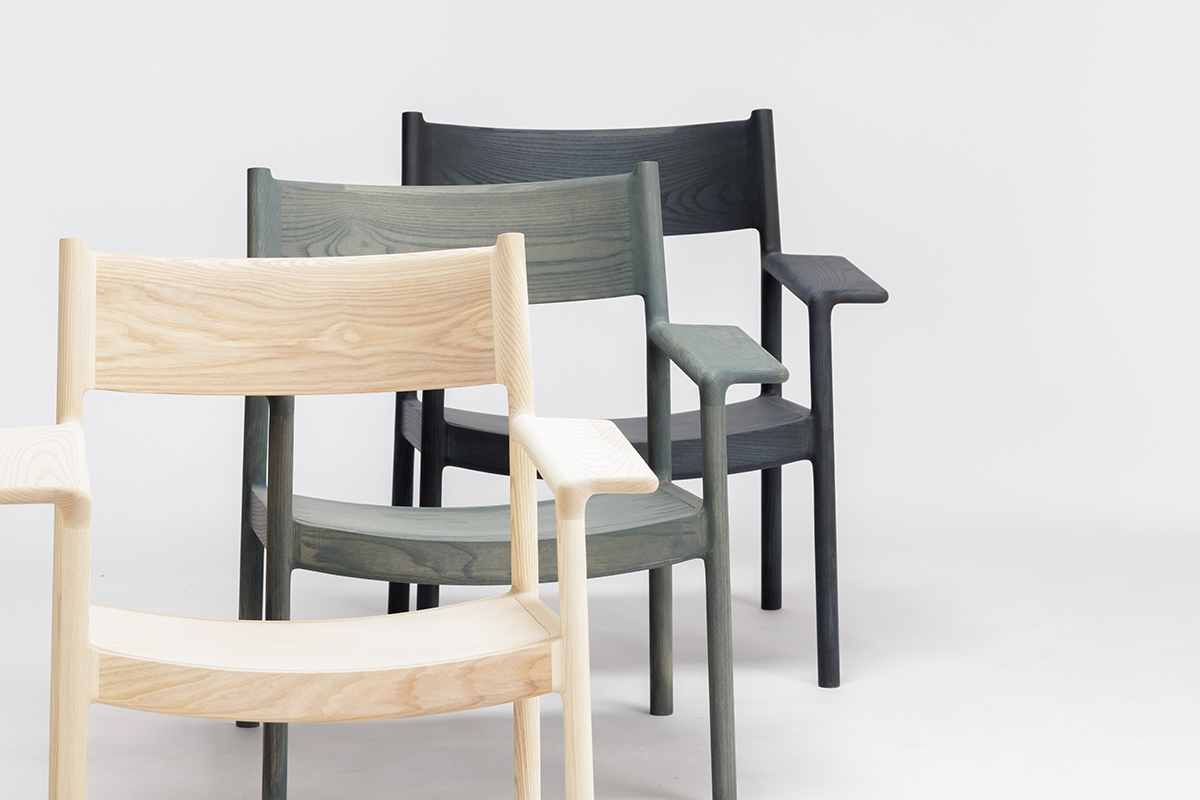 Hirata Gen Collection featuring the new GLC 01 lounge chair alongside complementary furniture pieces in various wood finishes.