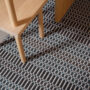 Each colour change in Ida’s pattern requires direct weaver attention — the result is a rich, tactile surface that rewards close inspection.